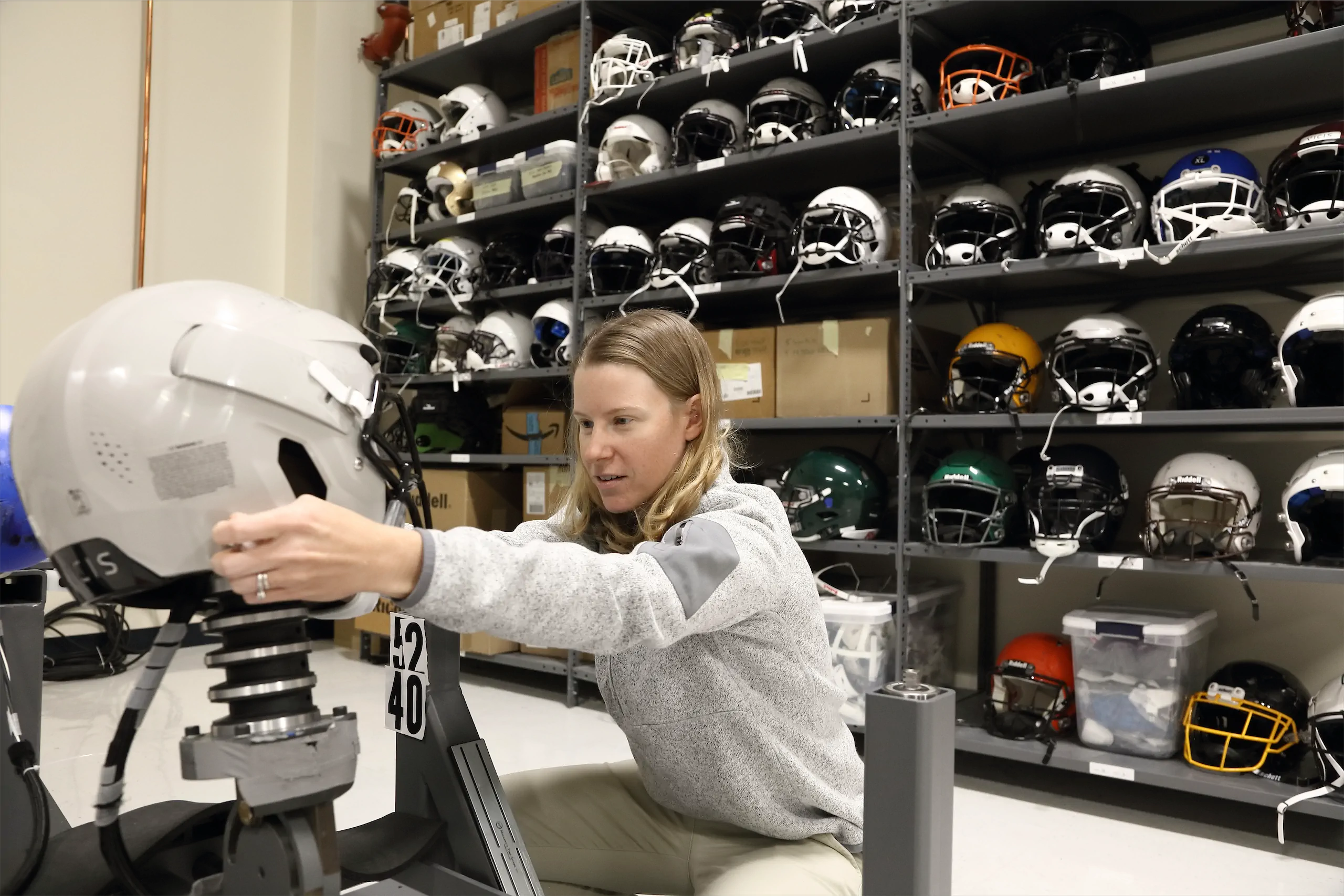 Engineer testing football helmet with impact tester